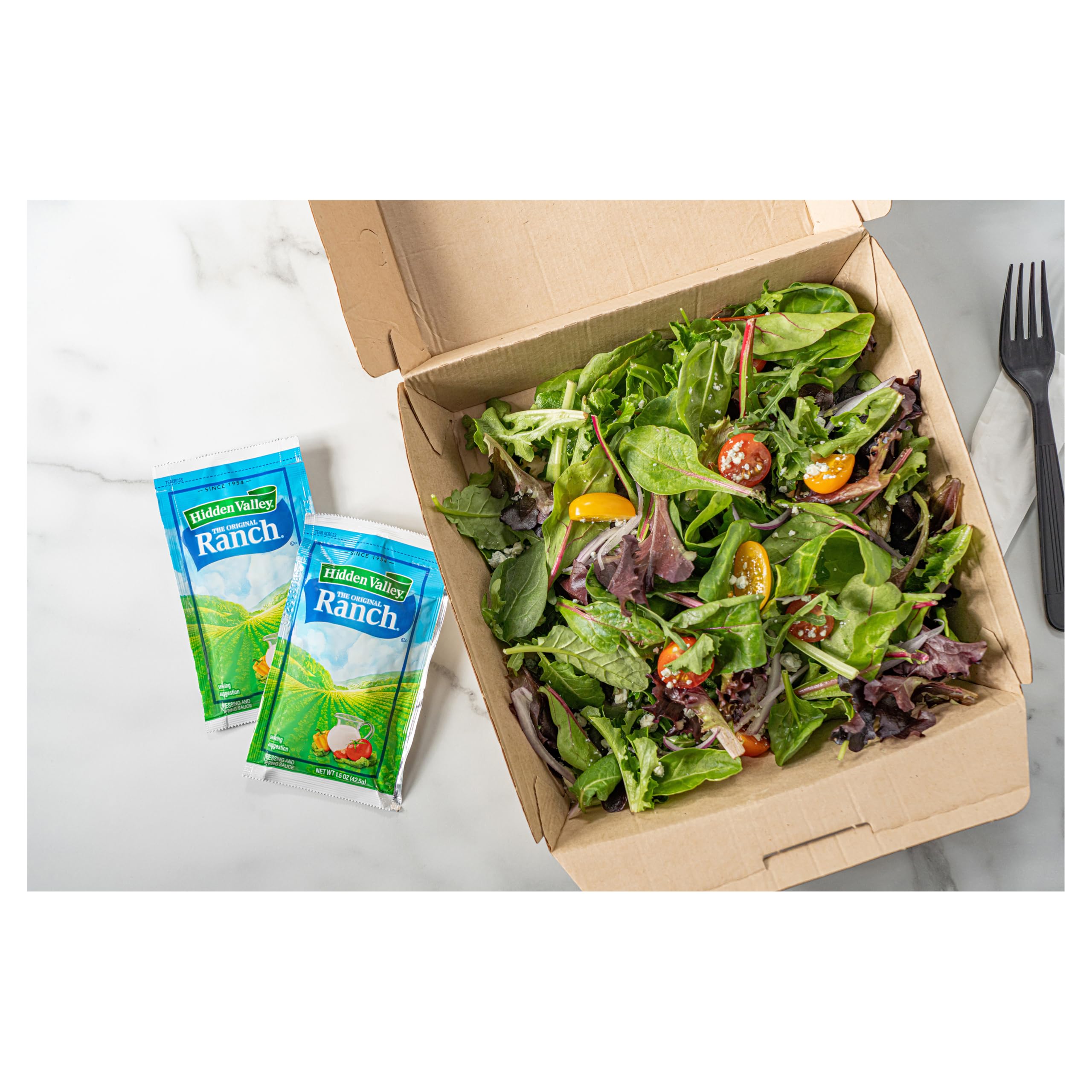 Hidden Valley Ranch dressing packets in a salad bar lineup.