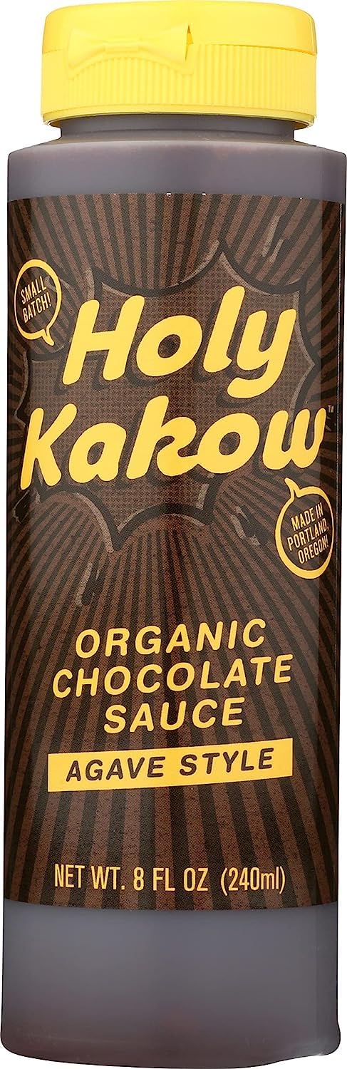 Holy Kakow Organic Chocolate Sauce bottle on the counter, perfect dessert topping.