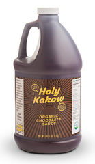 Holy Kakow Organic Chocolate Syrup bottle ready for rich drizzle over ice cream.