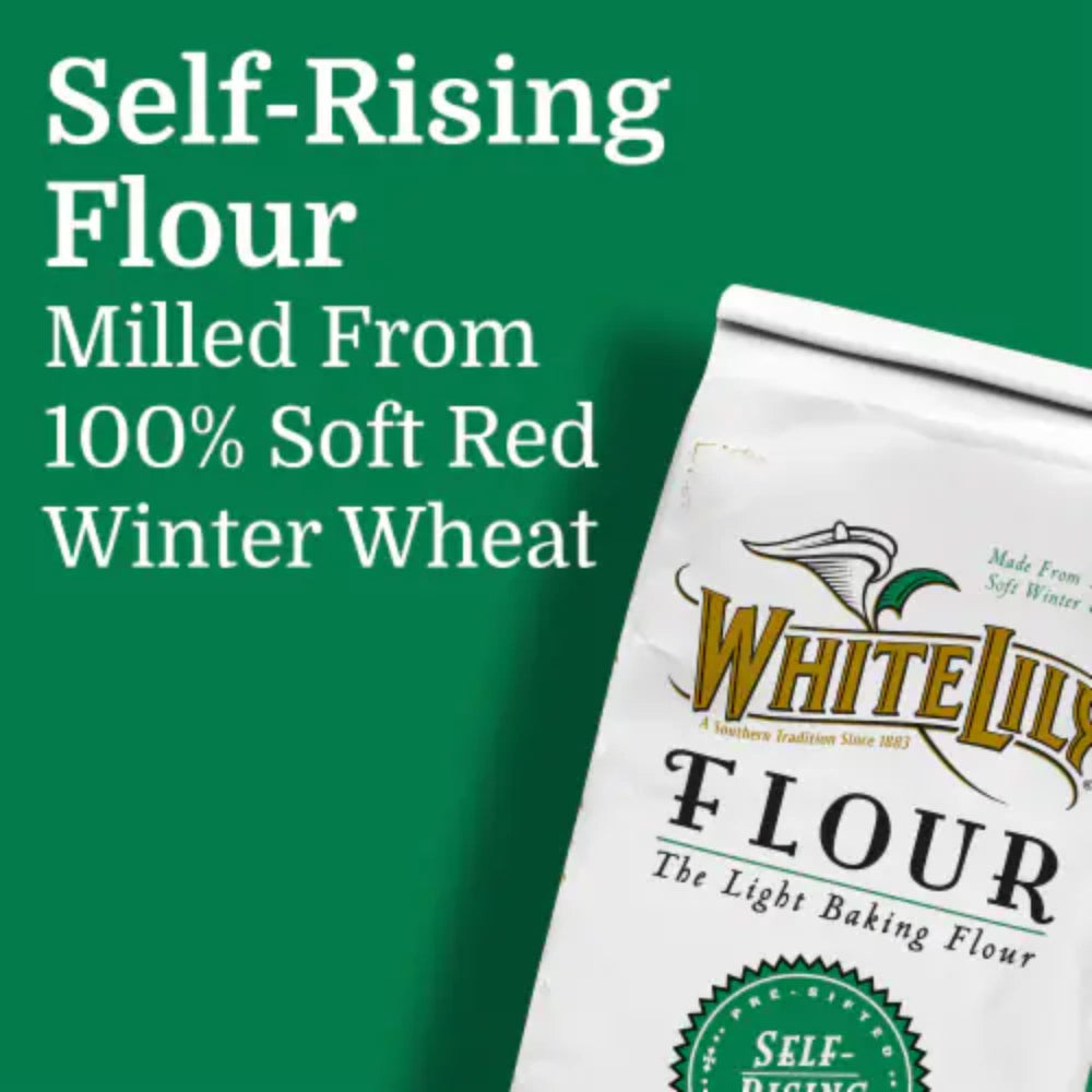 Measuring cup pouring flour for light-textured biscuits and quick breads.