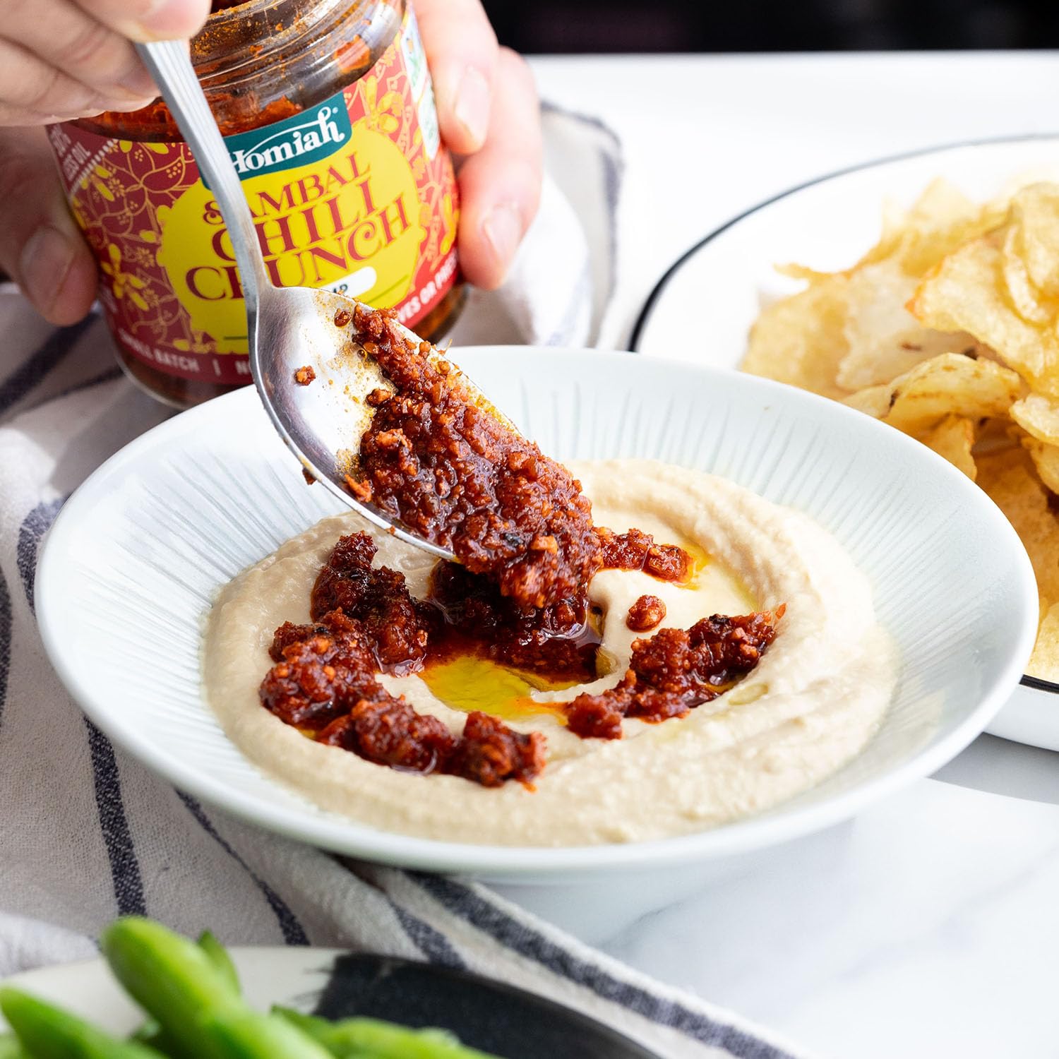 Jar of Homiah Sambal Chili Crunch Shrimp on kitchen counter inviting cooking