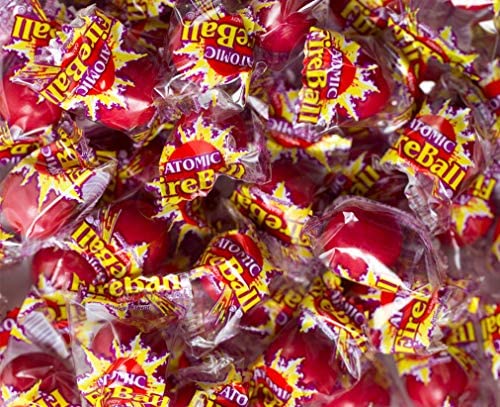 Homos Atomic FireBall candy in hand demonstrating portion size for sharing.