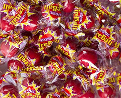Homos Atomic FireBall candy in hand demonstrating portion size for sharing.