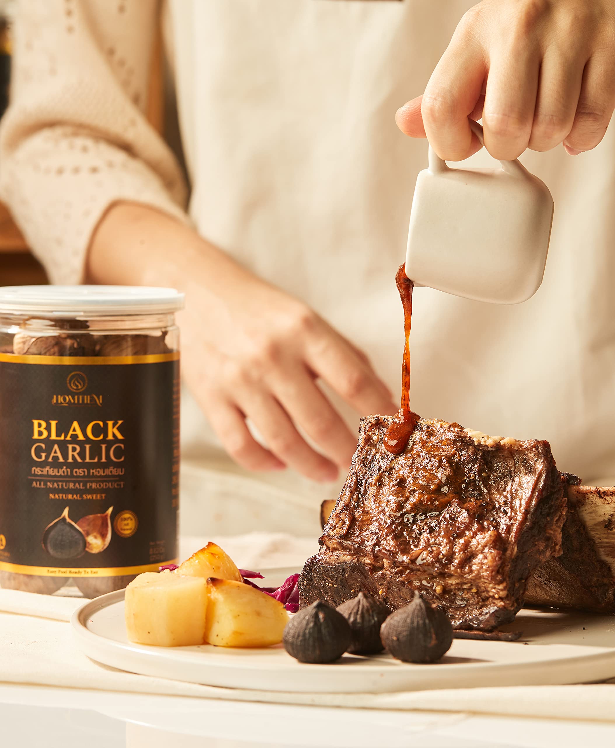 HOMTIEM Black Garlic packaging with GMP and HACCP details, reflecting quality standards.