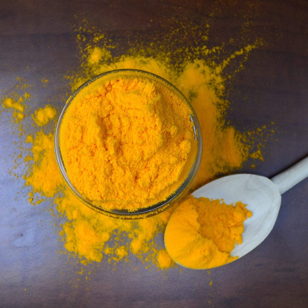 Hoosier Hill Farm Cheddar Cheese Powder used in a kitchen setup for recipes.