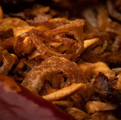Hot Crispy Oil Crispies finishing a pizza for crunch and depth.