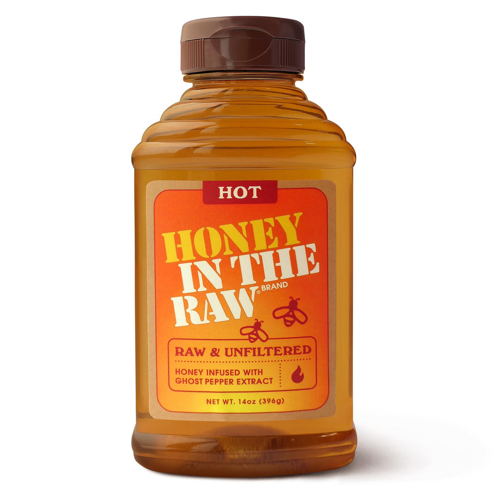 IN THE RAW Hot Honey bottle pouring, perfect for a sweet heat drizzle on pizza and cheese boards.
