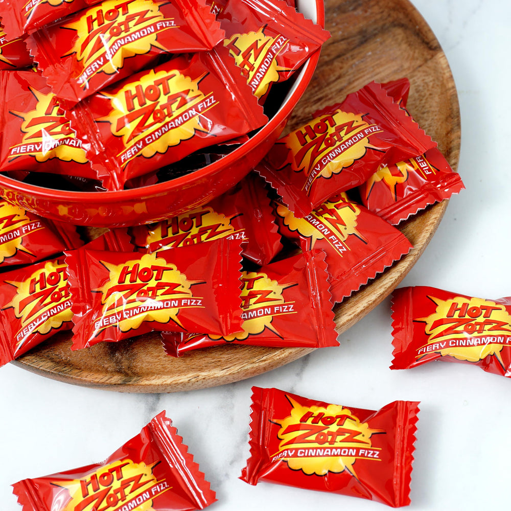 Party setup featuring Hot Zotz Fiery Cinnamon Fizz in a festive candy display