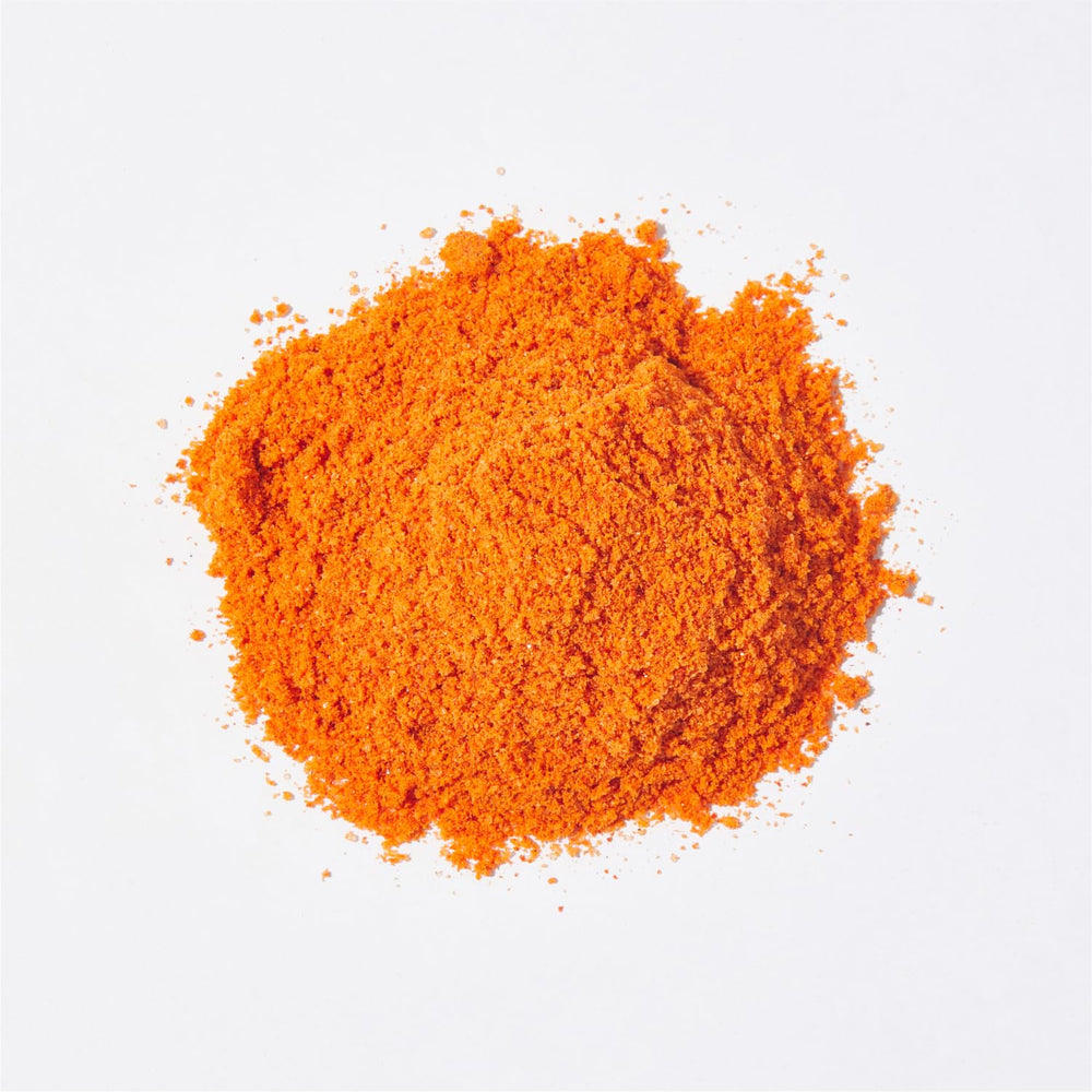 HOXY ramen seasoning on stir-fried veggies—visual of sauce-like mix creating savory glaze.