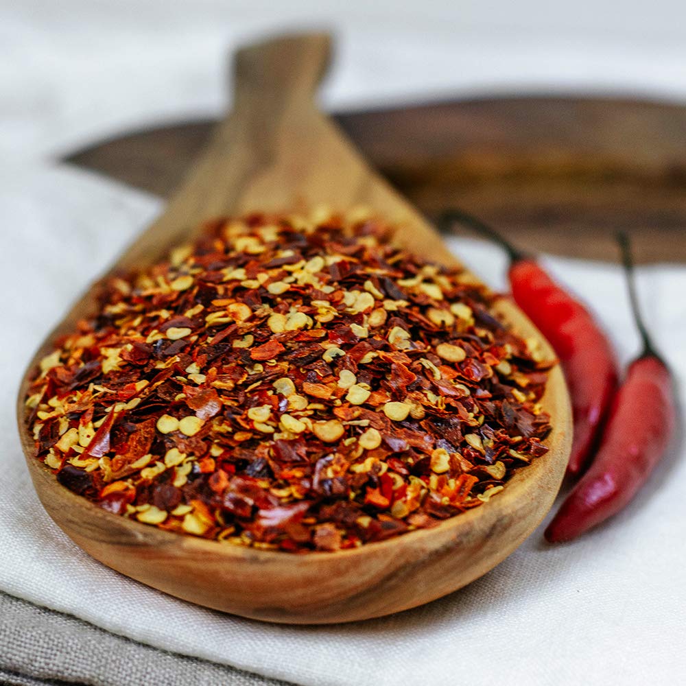 HQOExpress chili flakes on pizza for a spicy savory finish.