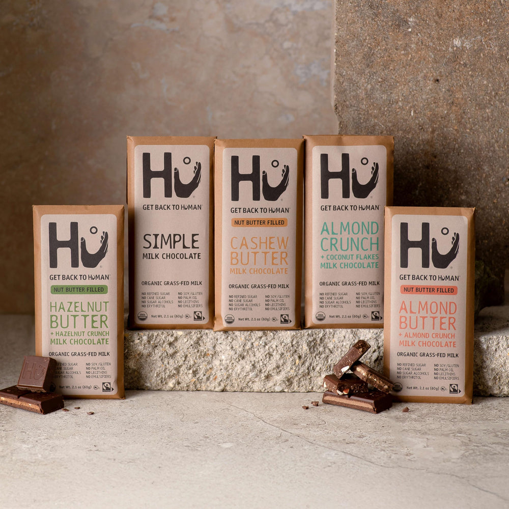 Hu Bar almond butter almond crunch mc slice photographed with coffee cup for pairing ideas.