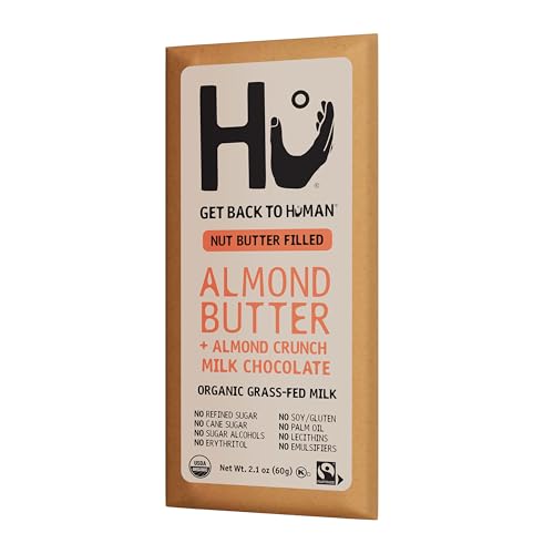 Hu Bar almond butter almond crunch mc crumbly bite next to a glass of milk.