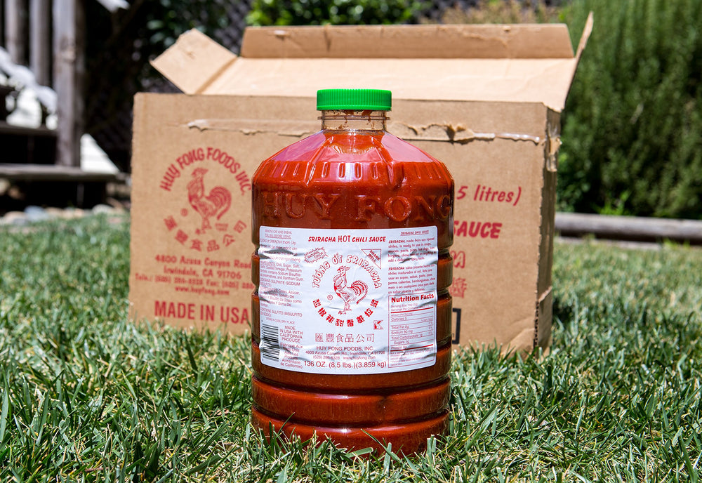 Huy Fong Sriracha sauce on noodles plate for quick fiery flavor boost