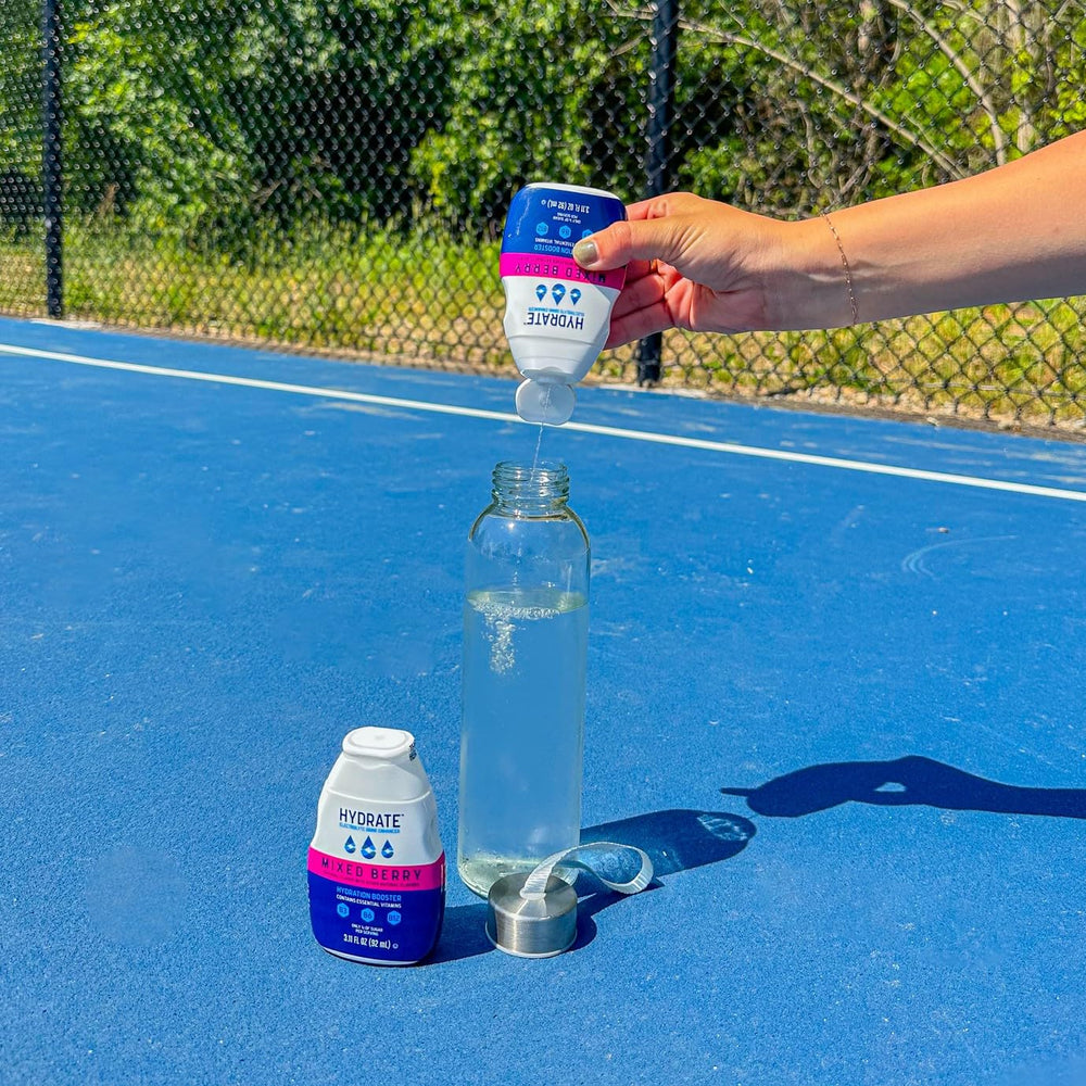 Sipping straw with berry swirl shows easy flavor infusion using Hydrate drops.