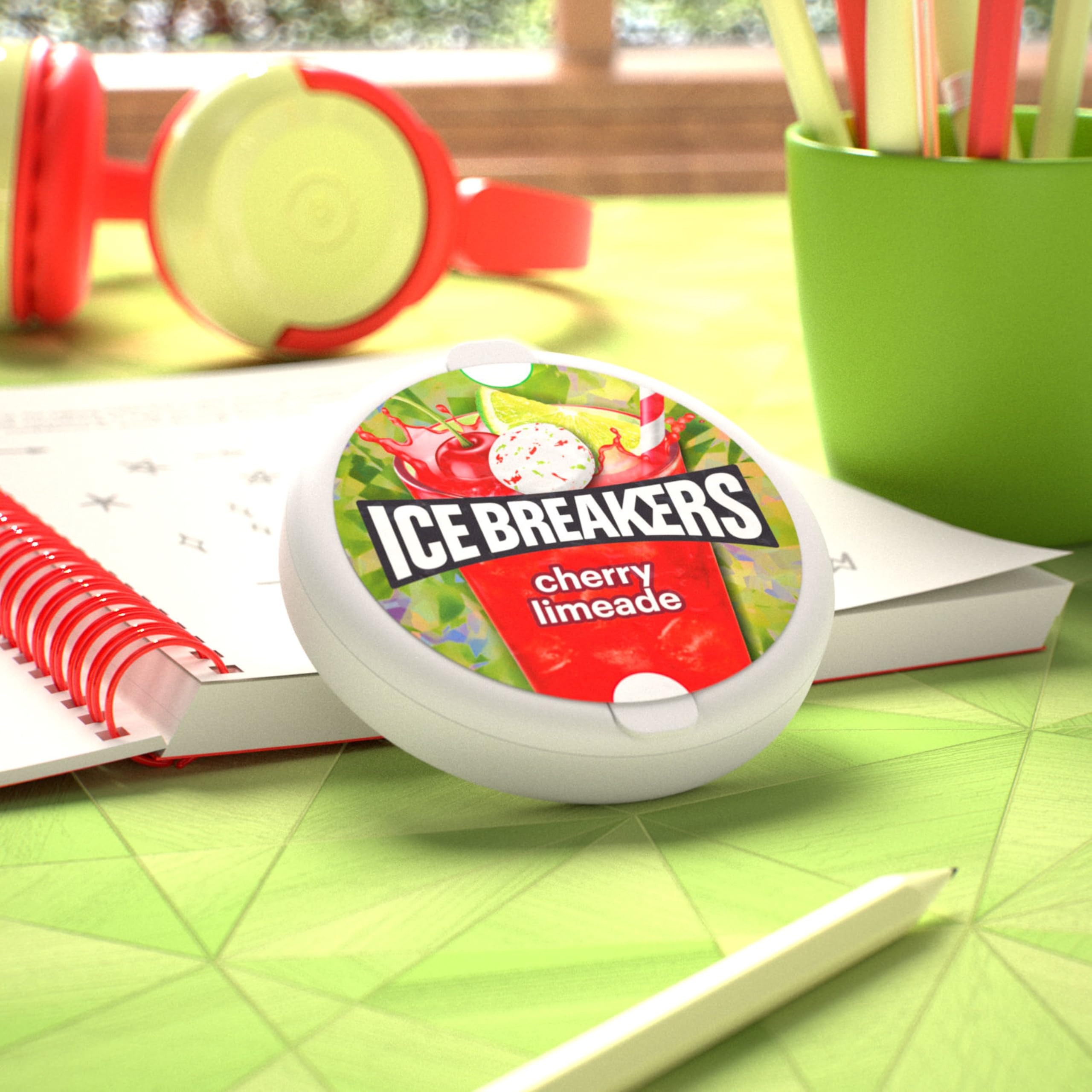 Ice Breakers Cherry Limeade mints tin on a desk for instant breath refreshment.