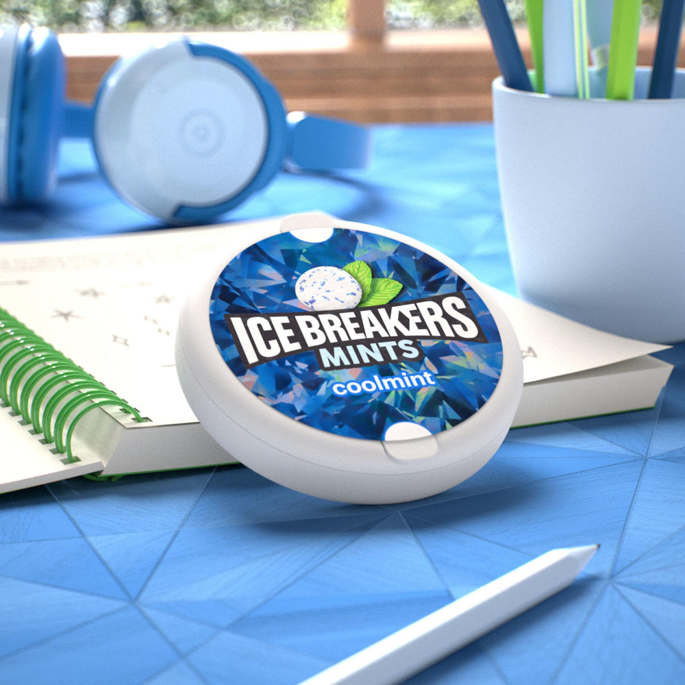 Ice Breakers Coolmint tin on desk suggests quick breath refresh during work.