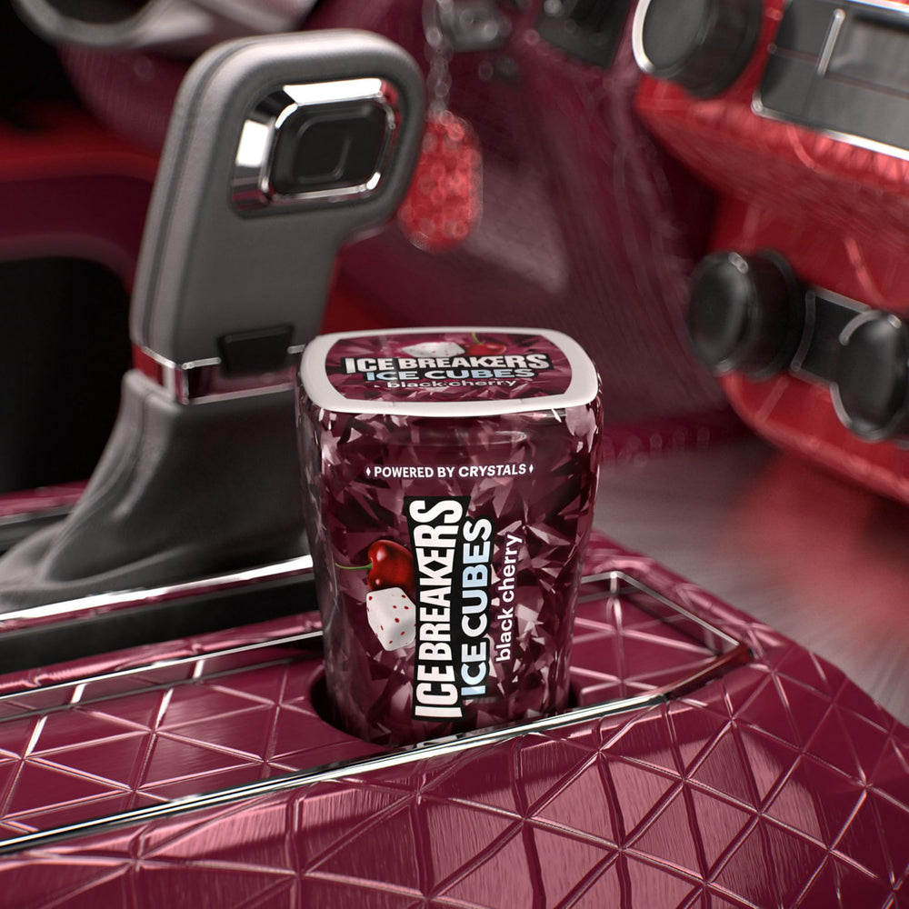 Ice Breakers Ice Cubes Black Cherry bottle in a car cup holder for quick refresh