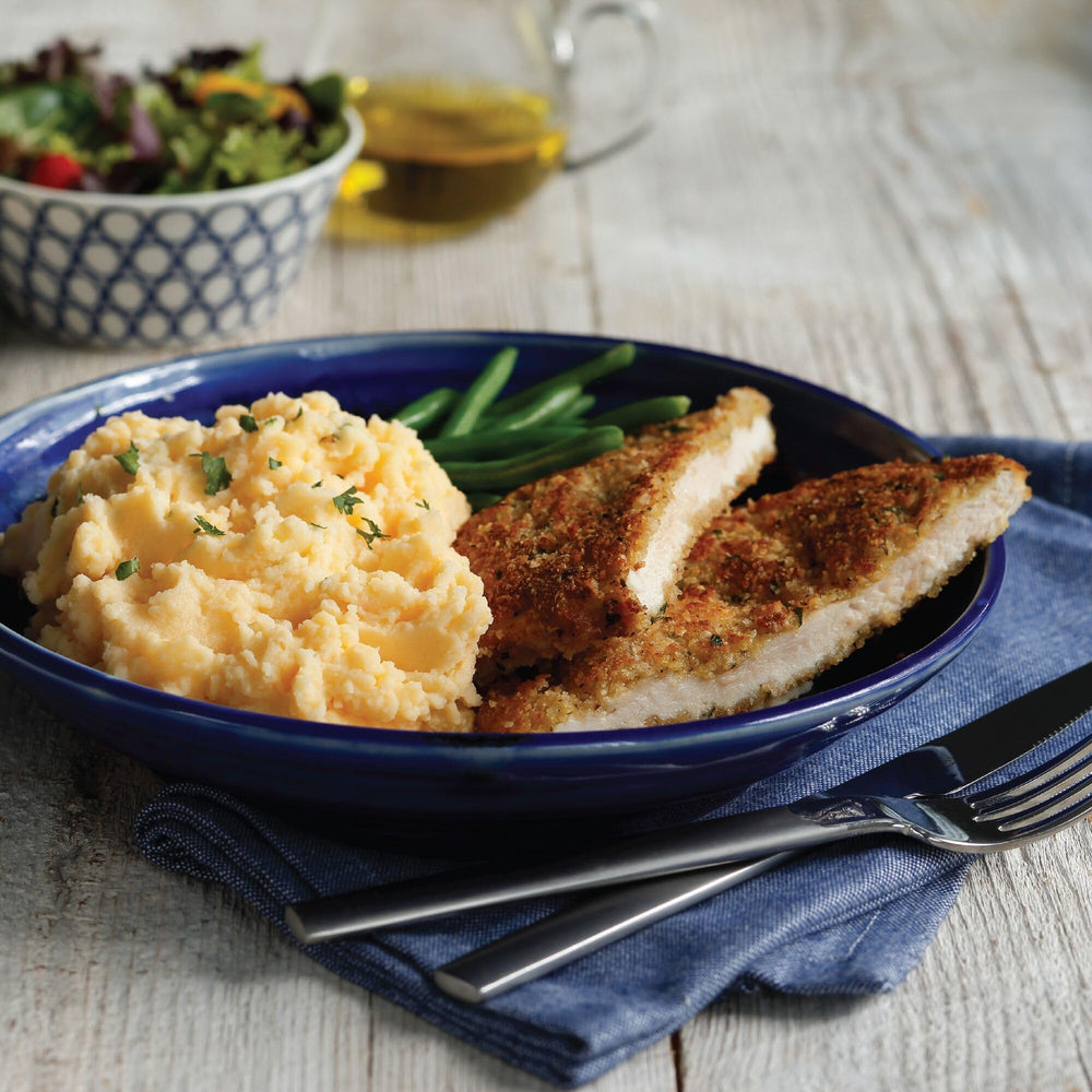 Idahoan Cheddar & Sour Cream mashed potatoes on kitchen table during dinner.