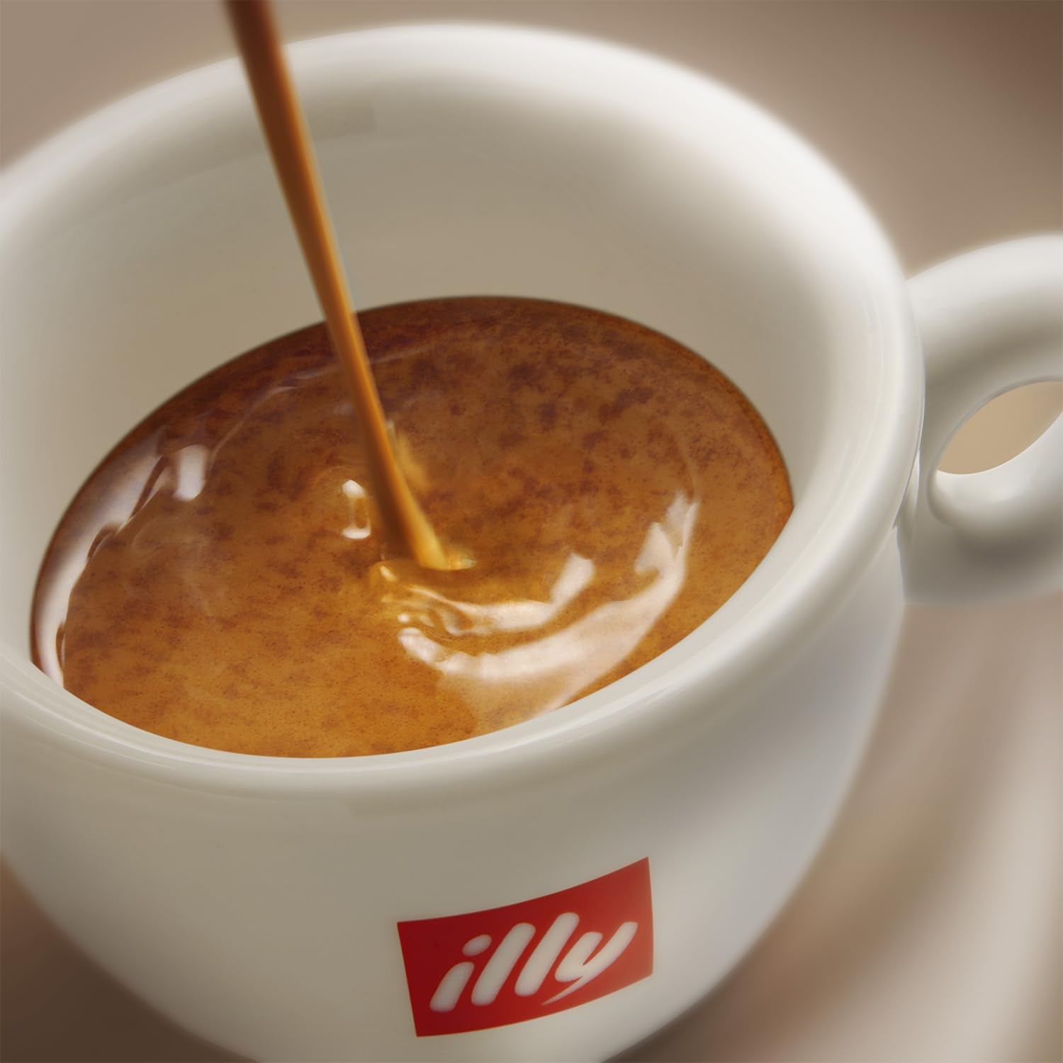 illy Ground Espresso Intenso Dark Roast cup ready for crema