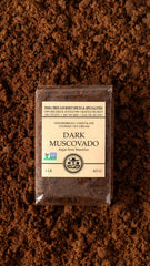 India Tree Dark Muscovado Sugar texture closeup reveals fine, moist crystals ideal for desserts.