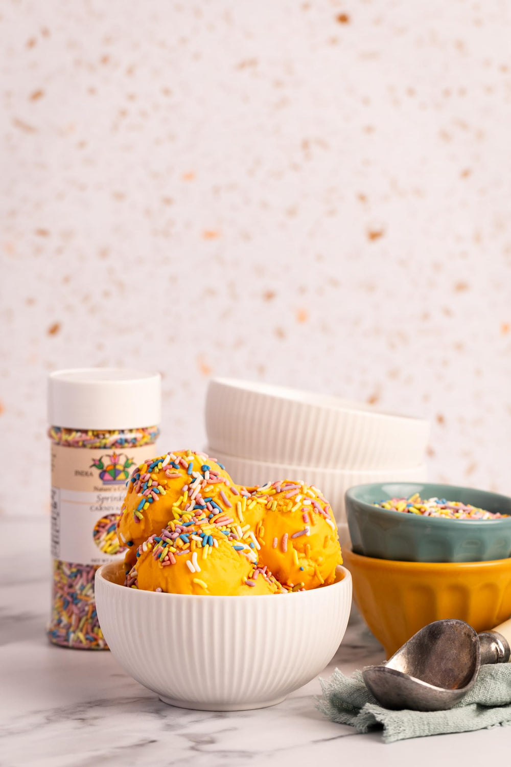 India Tree sprinkles on cookies for festive toppings