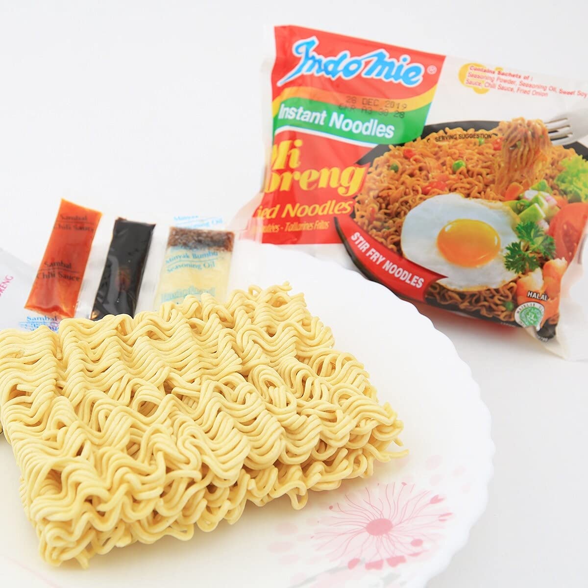 Stir-fry action shows savory glaze coating Mi Goreng noodles.