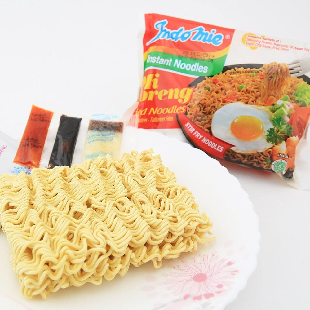 Stir-fry action shows savory glaze coating Mi Goreng noodles.