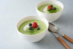 Cup of creamy matcha latte prepared with Ito En sticks at home.
