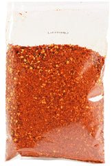 Jack Hua JHC extra-hot chili flakes on a spoon ready for quick heat.