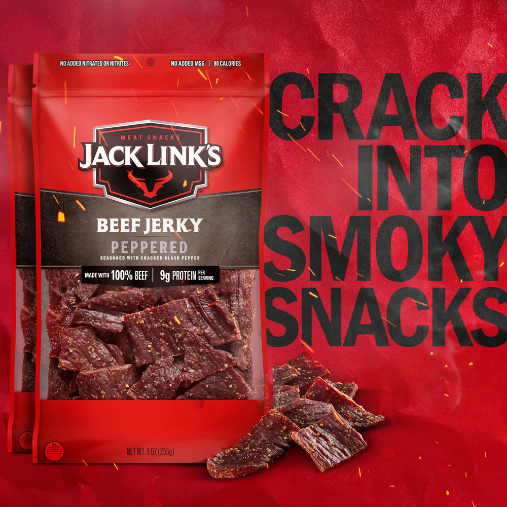 Jack Link's Peppered Beef Jerky strips on cutting board highlight rugged texture for craving bites.