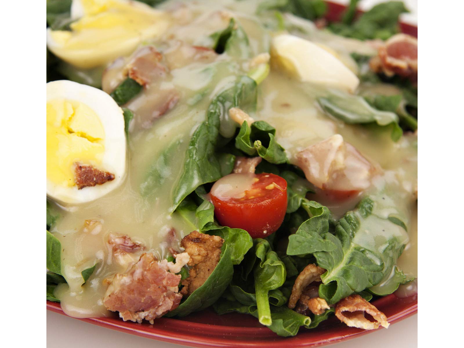 Jake & Amos Real Bacon Dressing drizzled on a crisp salad