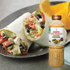 Pouring Japanese Deep Roasted Sesame Dressing over greens for vibrant salads.