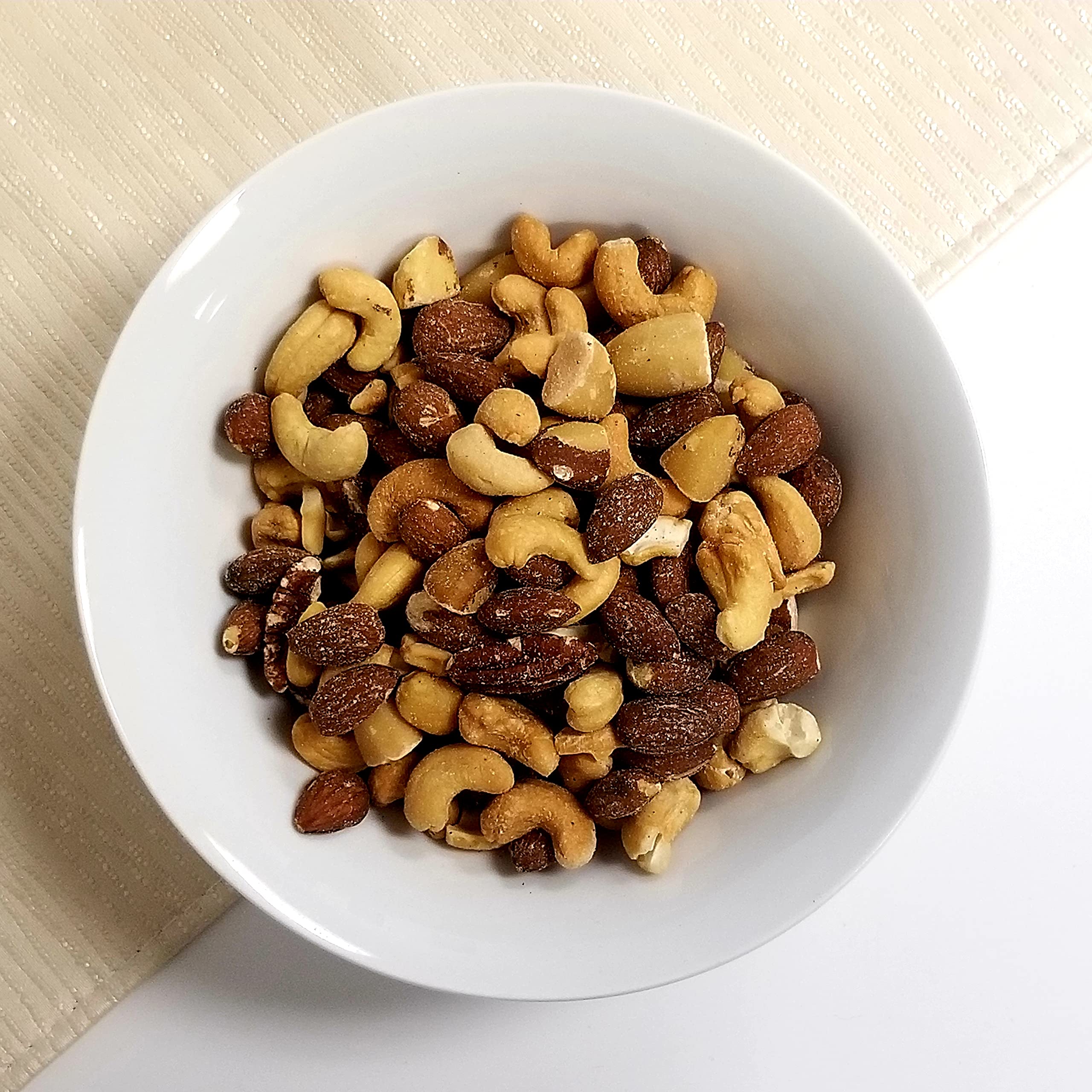 Pantry-friendly jar stores Jaybee's Deluxe nuts for easy snacking.