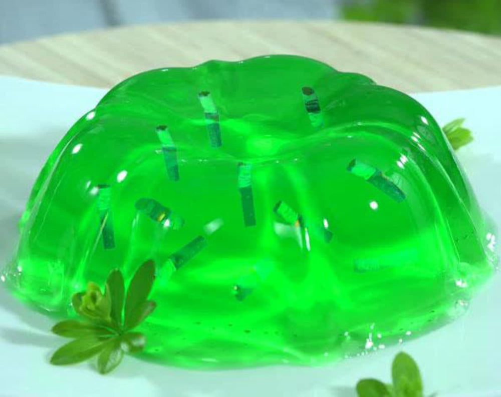 Stirring Jell-O lime sugar-free gelatin with cold water for a smooth set.