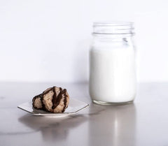 Jennies Coconut Bites dark chocolate detail highlighting smooth texture and vegan flavor.