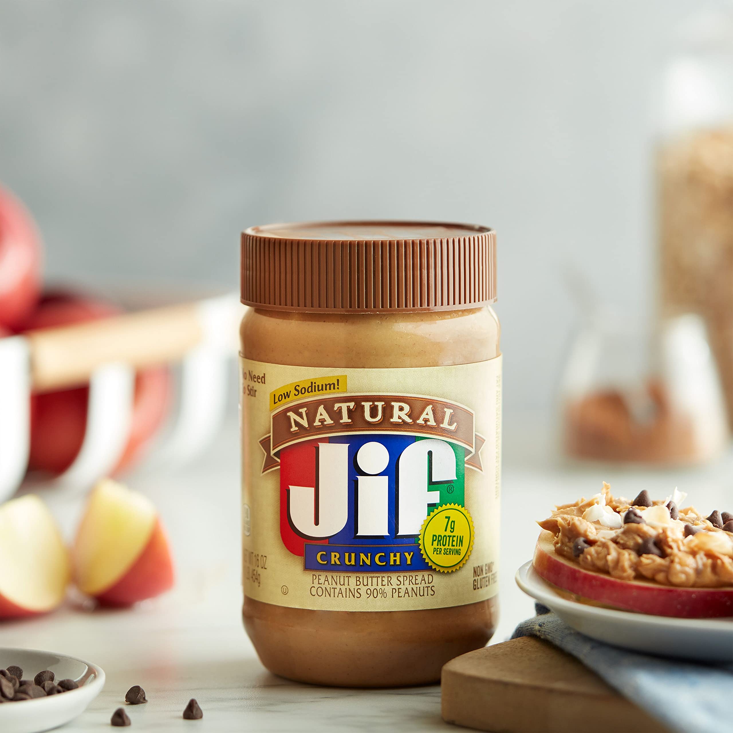 Pack of 12 Jif Natural Crunchy Peanut Butter Spread jars on kitchen counter