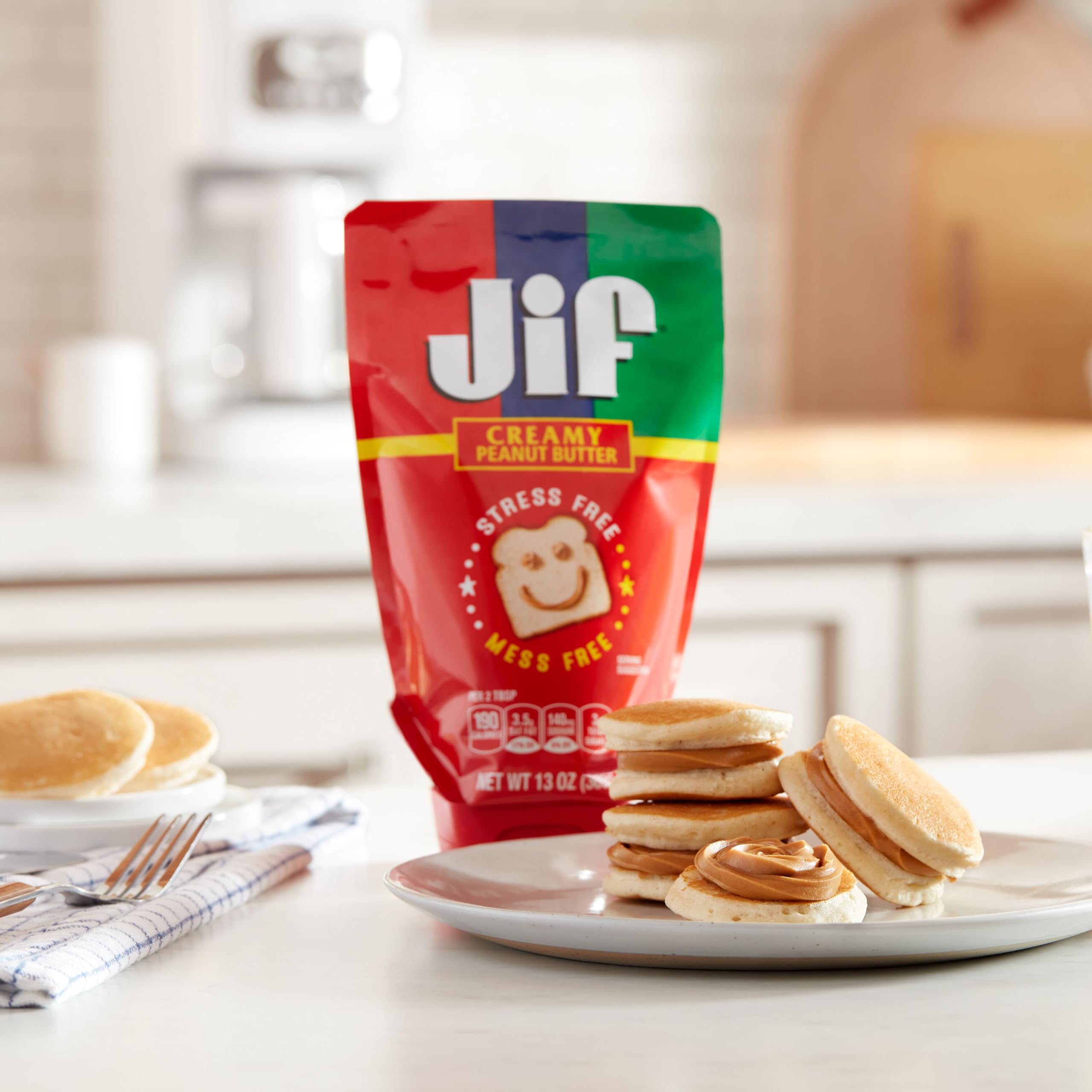 Jif Squeeze peanut butter in a lunchbox with fruit and crackers.