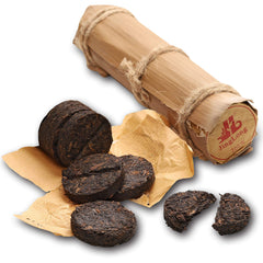 Jinglong Tea Factory Pu-erh tube with bamboo leaves for portable tea.