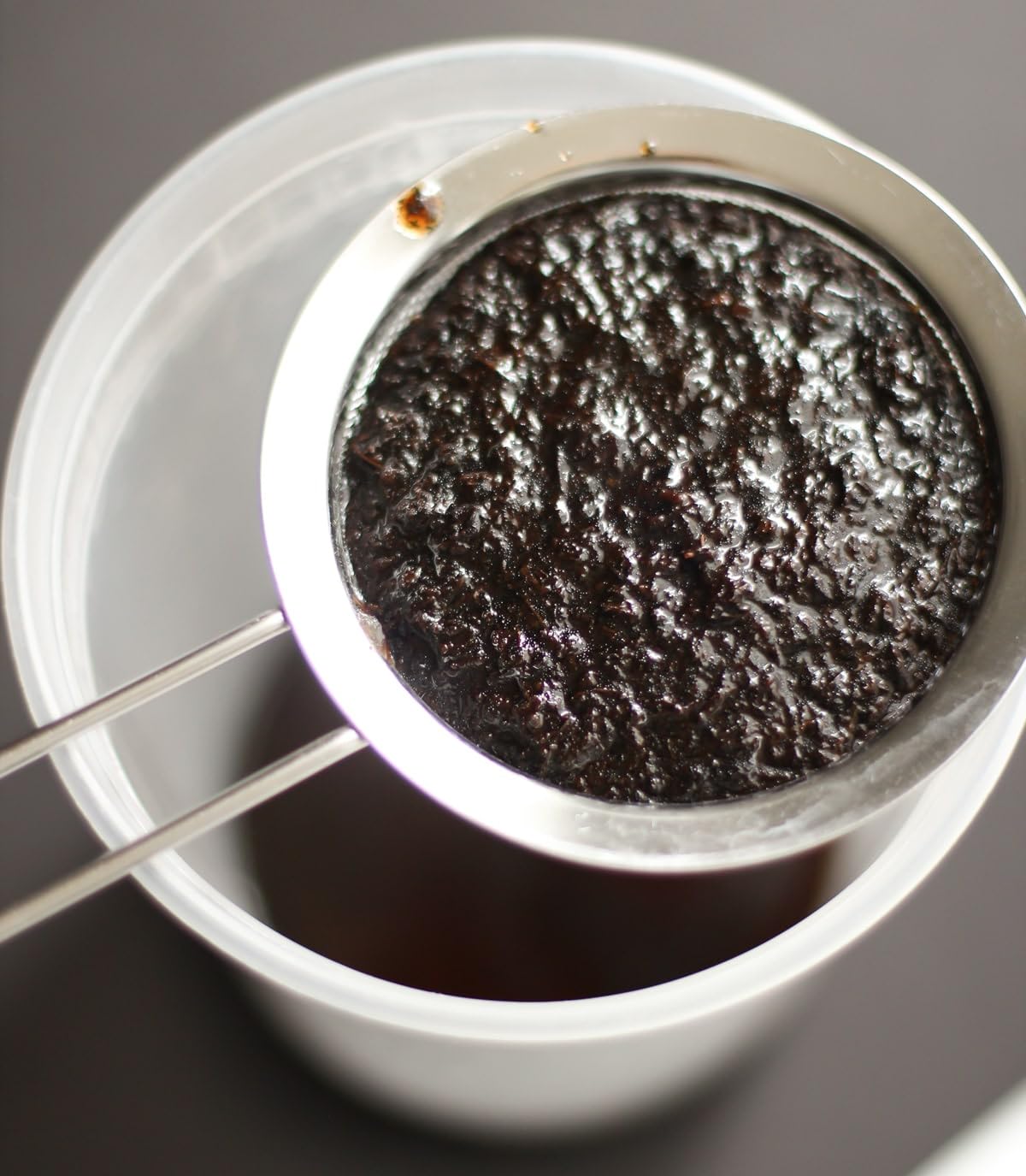 Close-up of JL Gourmet Imports vanilla bean paste texture with real vanilla specks