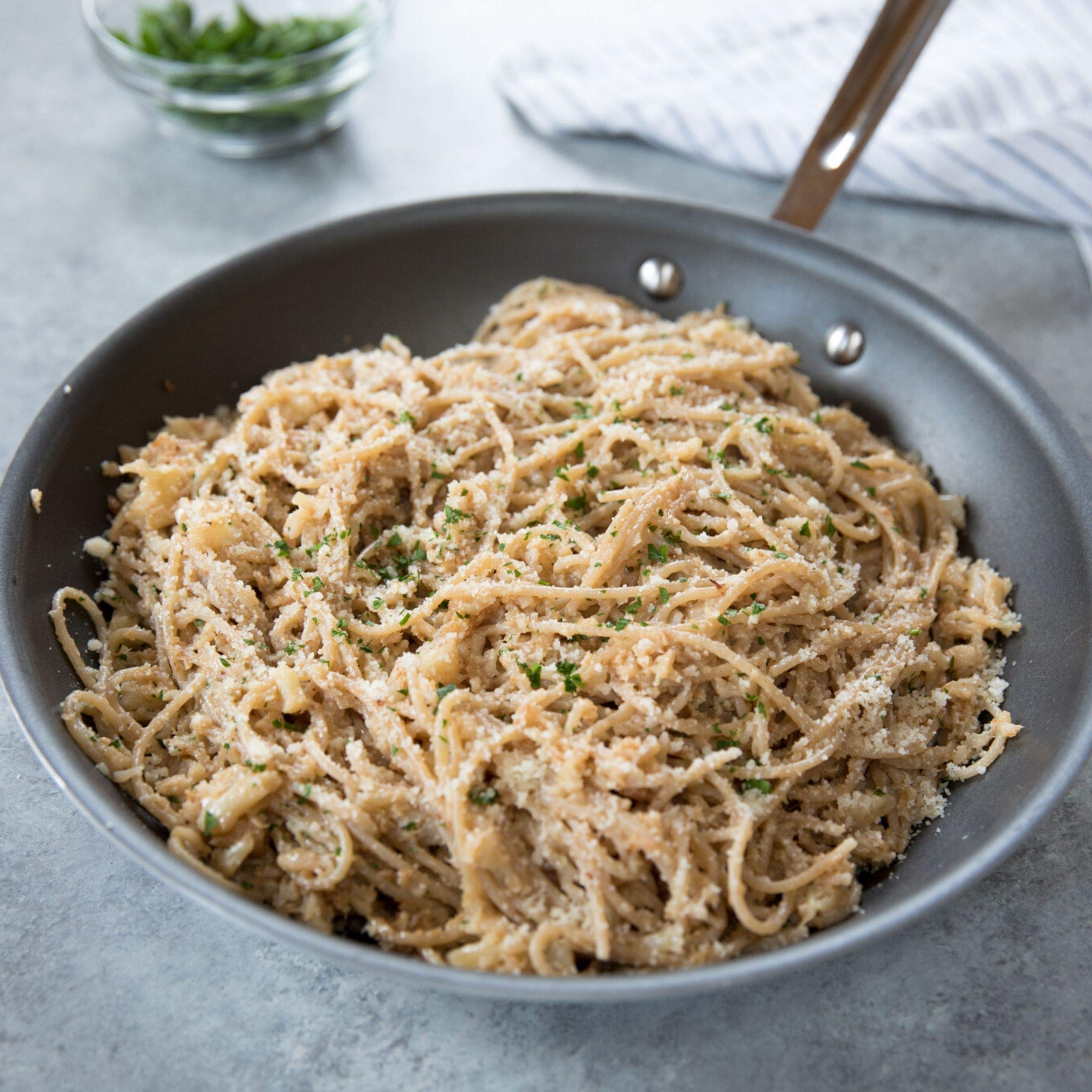 Jovial Brown Rice Capellini plated with light olive oil and herbs.
