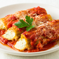 Jovial brown rice manicotti simmering in a pot during cooking.