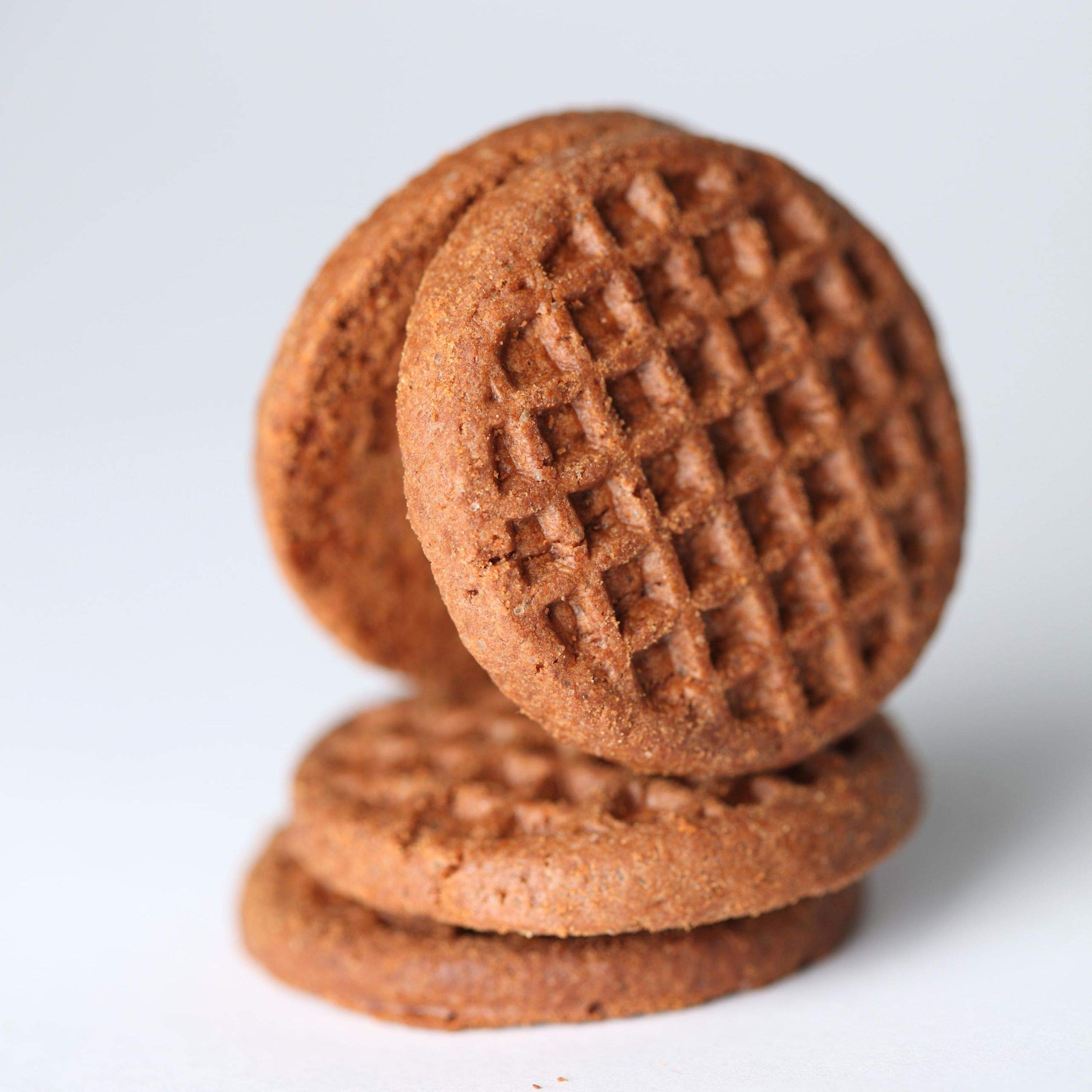 Jovial Einkorn Crispy Cocoa Cookies being dipped into coffee for dunking