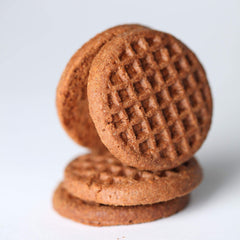 Jovial Einkorn Crispy Cocoa Cookies being dipped into coffee for dunking