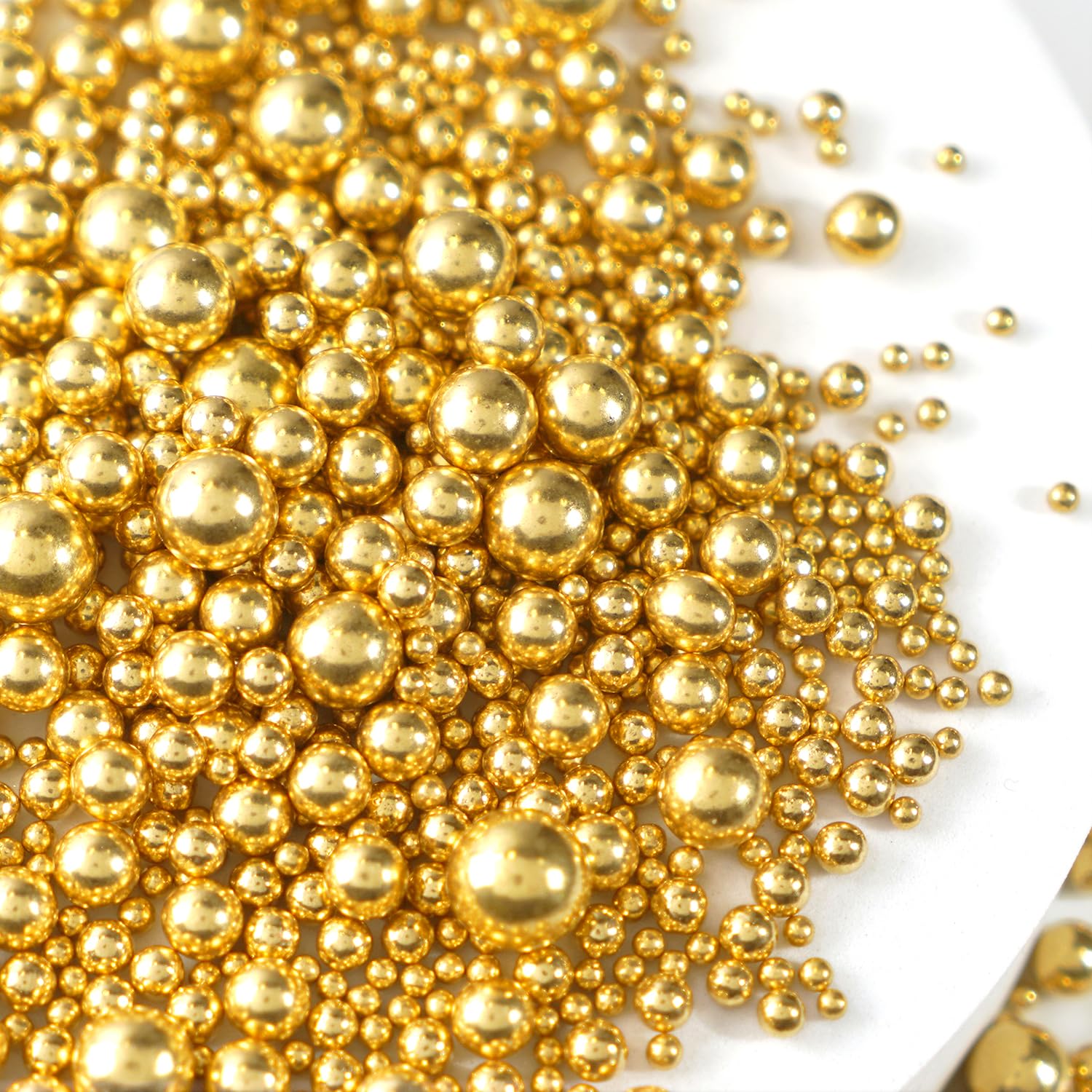 Joyvitas Gold Pearl Sprinkles on a cake, giving an elegant shimmering finish
