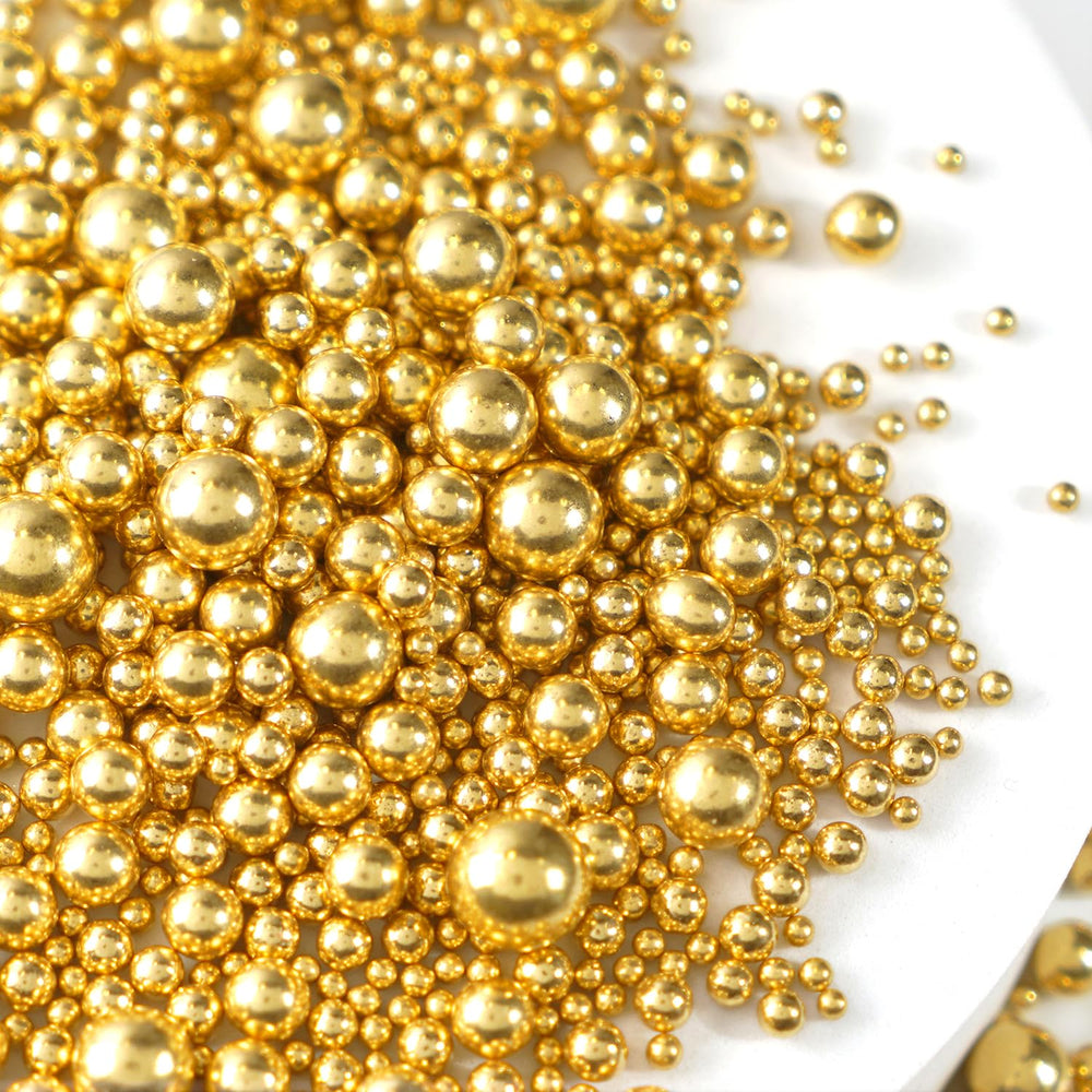 Joyvitas Gold Pearl Sprinkles on a cake, giving an elegant shimmering finish
