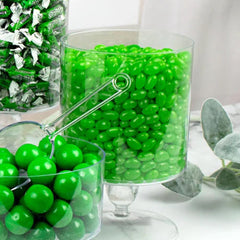 Just Candy green apple jelly beans closeup with glossy coating for a tasty treat.
