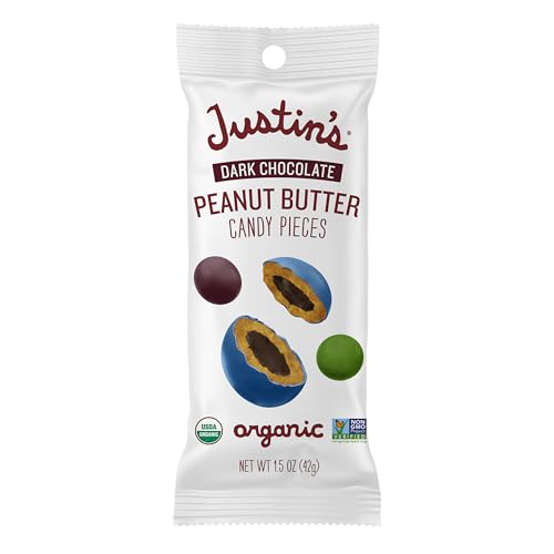 Justin's dark chocolate peanut butter candy pieces 1.5 oz bag in hand, a portable treat.