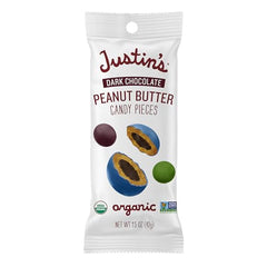 Justin's dark chocolate peanut butter candy pieces 1.5 oz bag in hand, a portable treat.