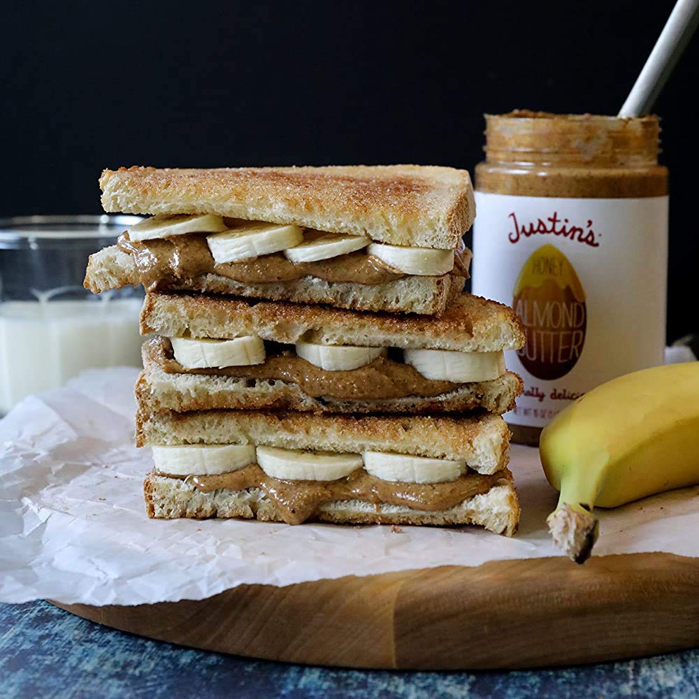 Justin's Honey Almond Butter spread on apple slices for a wholesome snack