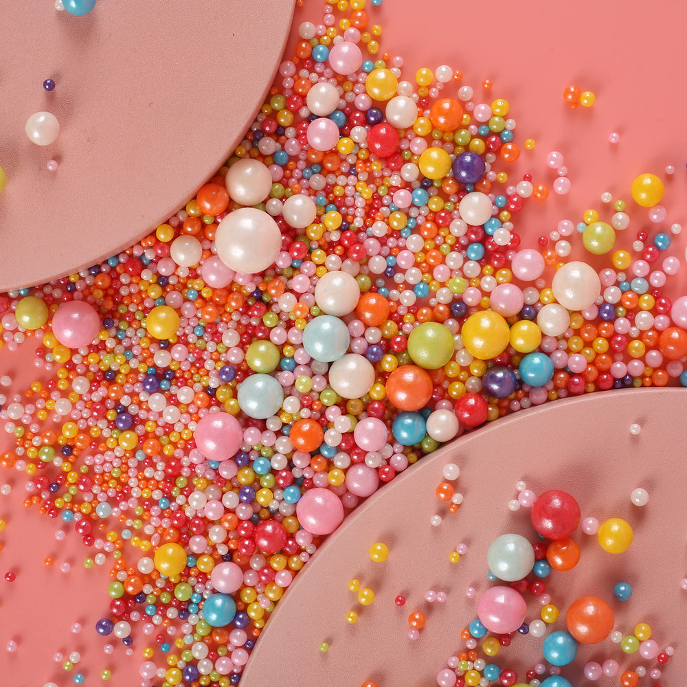Kasvan mixed pearl sugar sprinkles on cupcakes for festive flair.